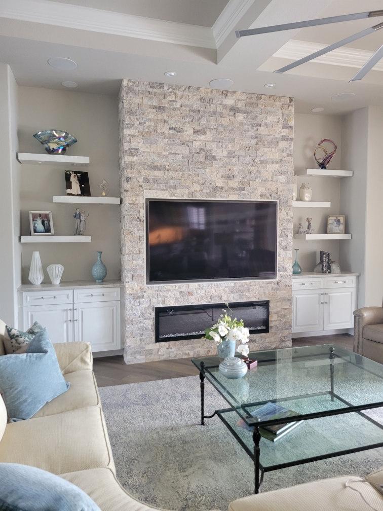Camara Construction completed living room renovation with stone fireplace